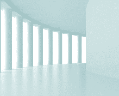 white architecture pillars in long hallway
