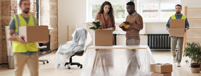 manager ovrseeing employees packing up their office