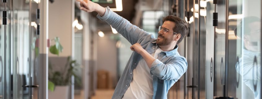 Happy motivated male employee cheering with excitement after receiving a reward