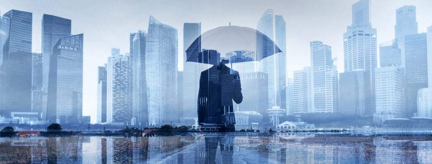 man under umbrella in front of city skyline