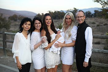 Kimberly Clark and her new baby with her parents and sisters