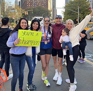 Kimberly and Tyler at a marathon with family cheering them on