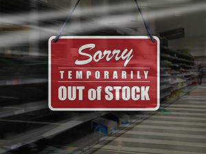 Business concept of empty store shelves with 'Sorry, Temporarily Out of Stock' sign.