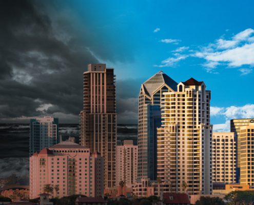 skyline view of Downtown San Diego with dark clouds on the left and sunny skies on the right