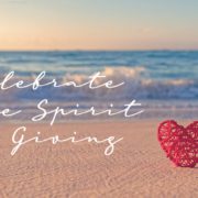 Celebrate the Spirit of Giving overlayed on a beach photo with a red heart on the sand