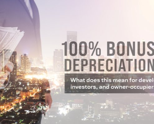 100 percent bonus depreciation text on image of man holding cash superimposed on city skyline