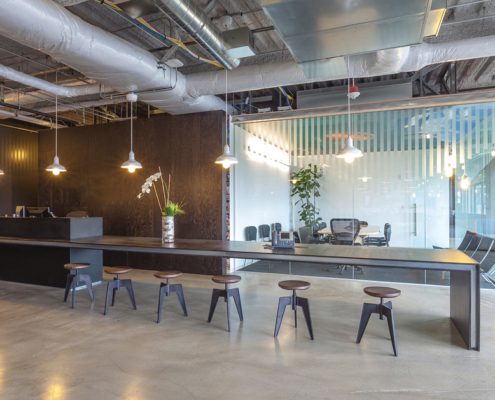 empty high end office space with reception area long shared desk and conference room