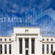 Interest Rate reduction graph and city skyline overlay on Federal Reserve Building