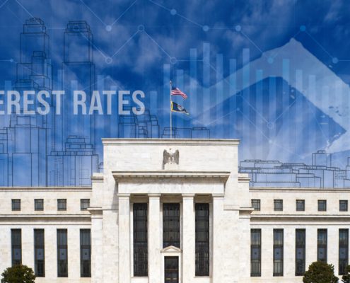Interest Rate reduction graph and city skyline overlay on Federal Reserve Building