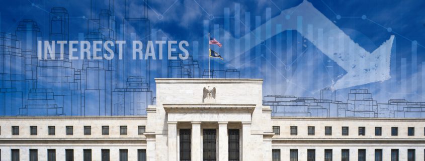 Interest Rate reduction graph and city skyline overlay on Federal Reserve Building