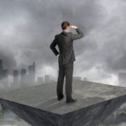 Decision maker looking out over a city with clouds interfering with his view