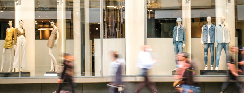 Blurred people walking past a retail department store