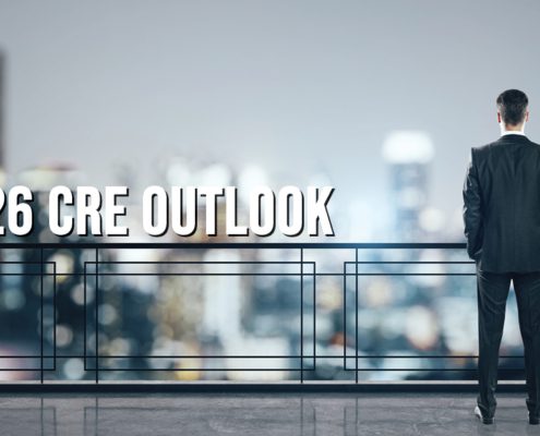 2026 CRE Outlook overlay on photo of businessman on balcony looking at skyline
