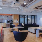 Modern office lounge with movie screen and meeting areas