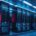 A server room illuminated with blue and red lights, highlighting the data center infrastructure and the critical role of technology in modern data management systems