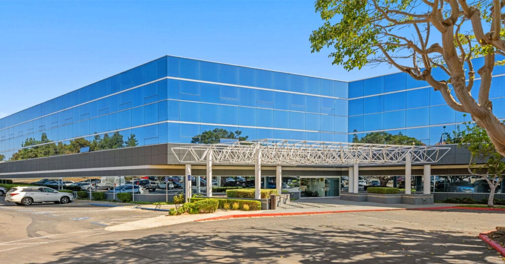 Photo of the front entrance of 6060 Cornerstone Ct W a blue glass building