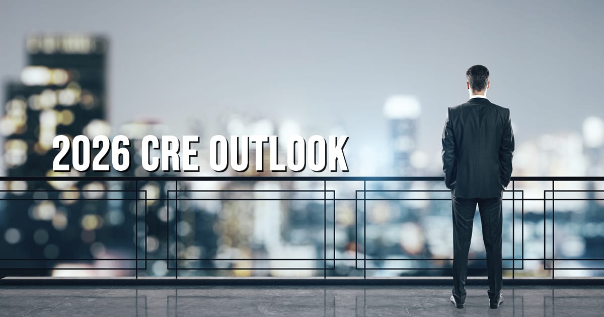 2026 CRE Outlook overlay on photo of businessman on balcony looking at skyline