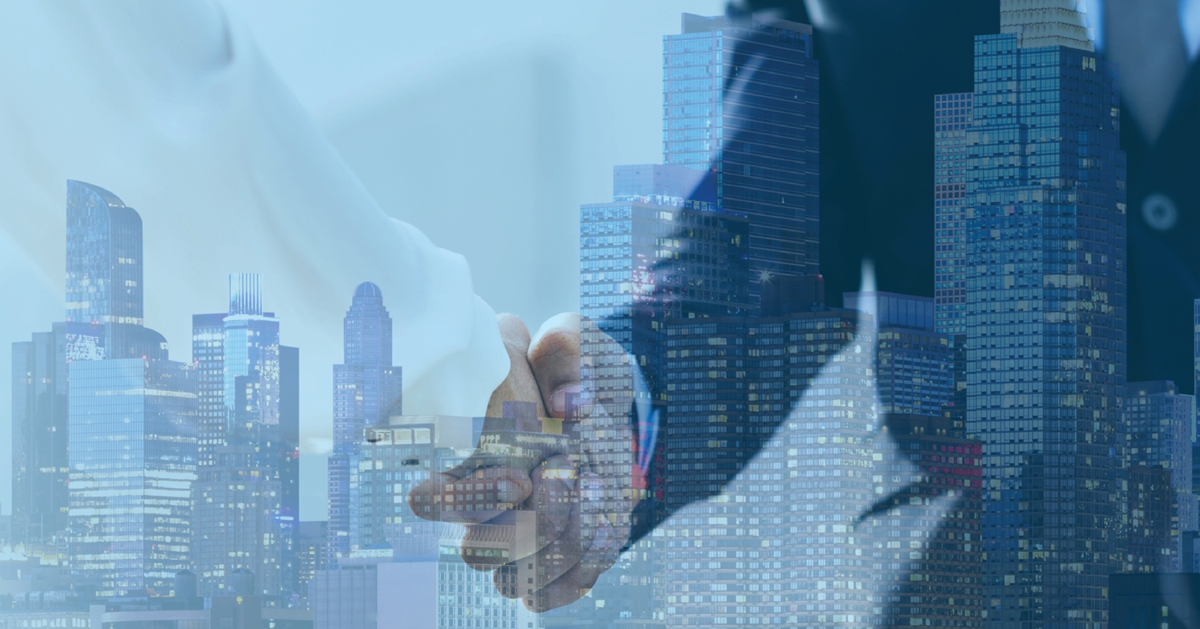 Closing CRE transaction with a handshake overlayed on the skyline of a major city